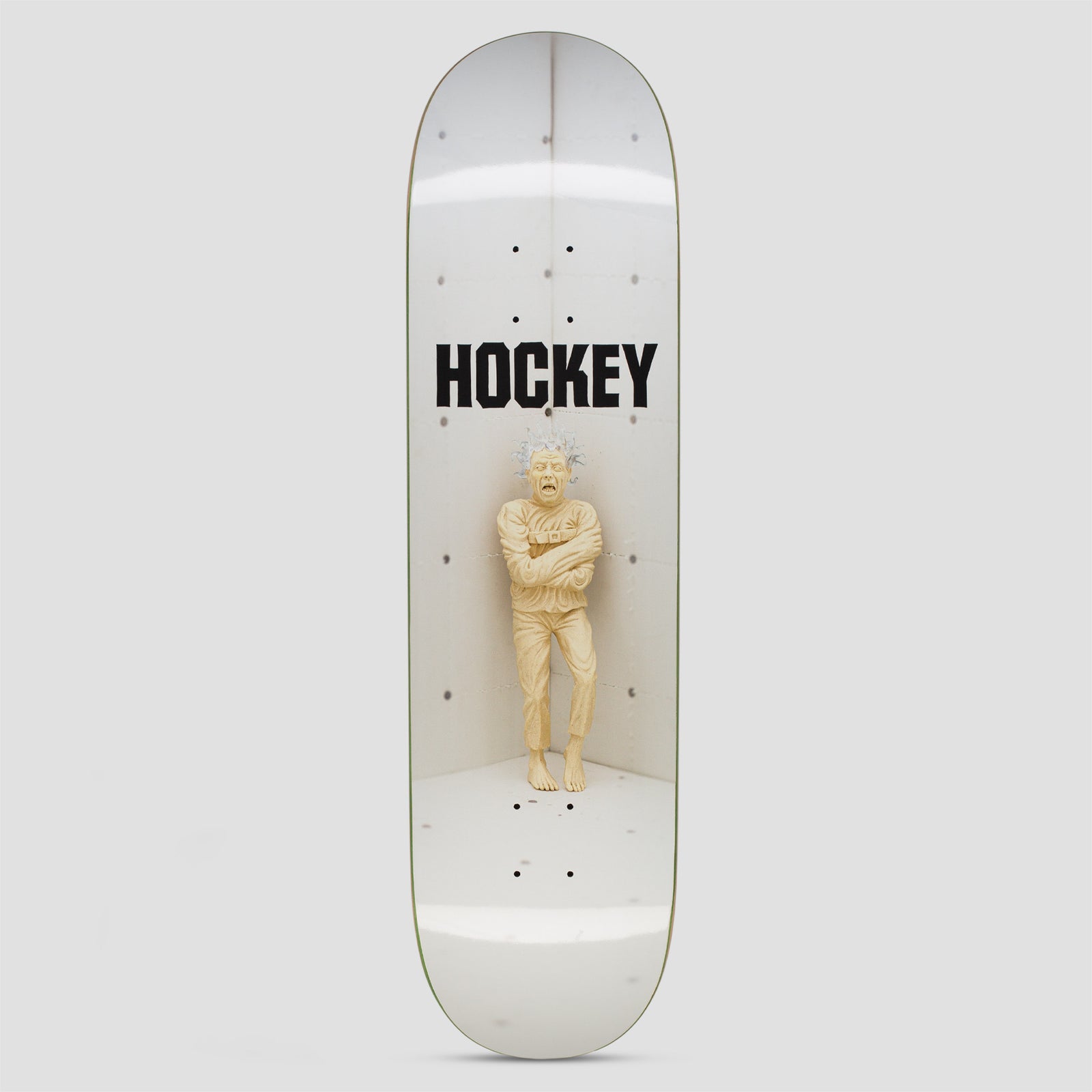 Hockey Hatch Ben Kadow skateboard deck: Photo of a pale sculpture of a wild-haired man in a straitjacket standing in the corner of a white concrete room, with the Hockey logo in black capitals above.