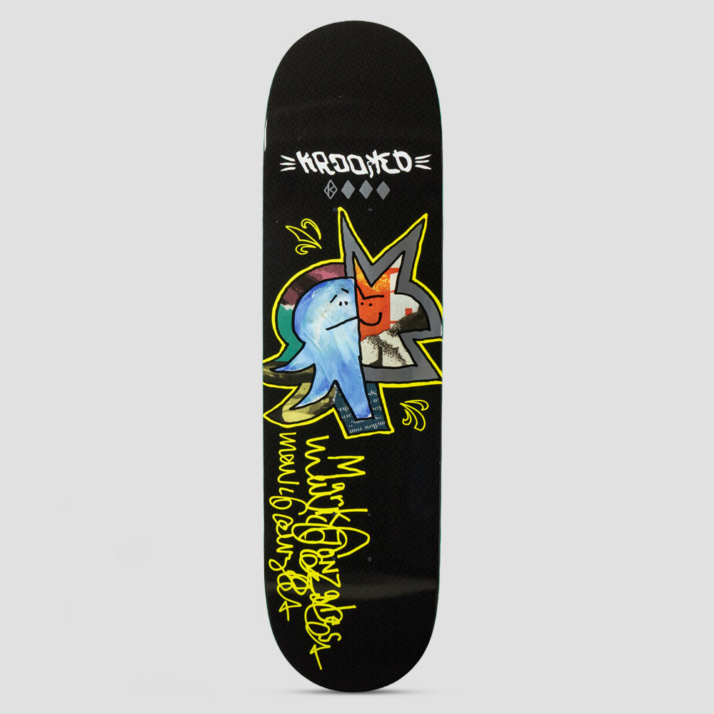 Krooked Gonz Sig Black skateboard deck: Collage-style star shape outlined in yellow marker with a painted blue ghostly figure on one side and an orange smiling face on the other, with handwritten yellow signature lettering below. Krooked logo at the nose.