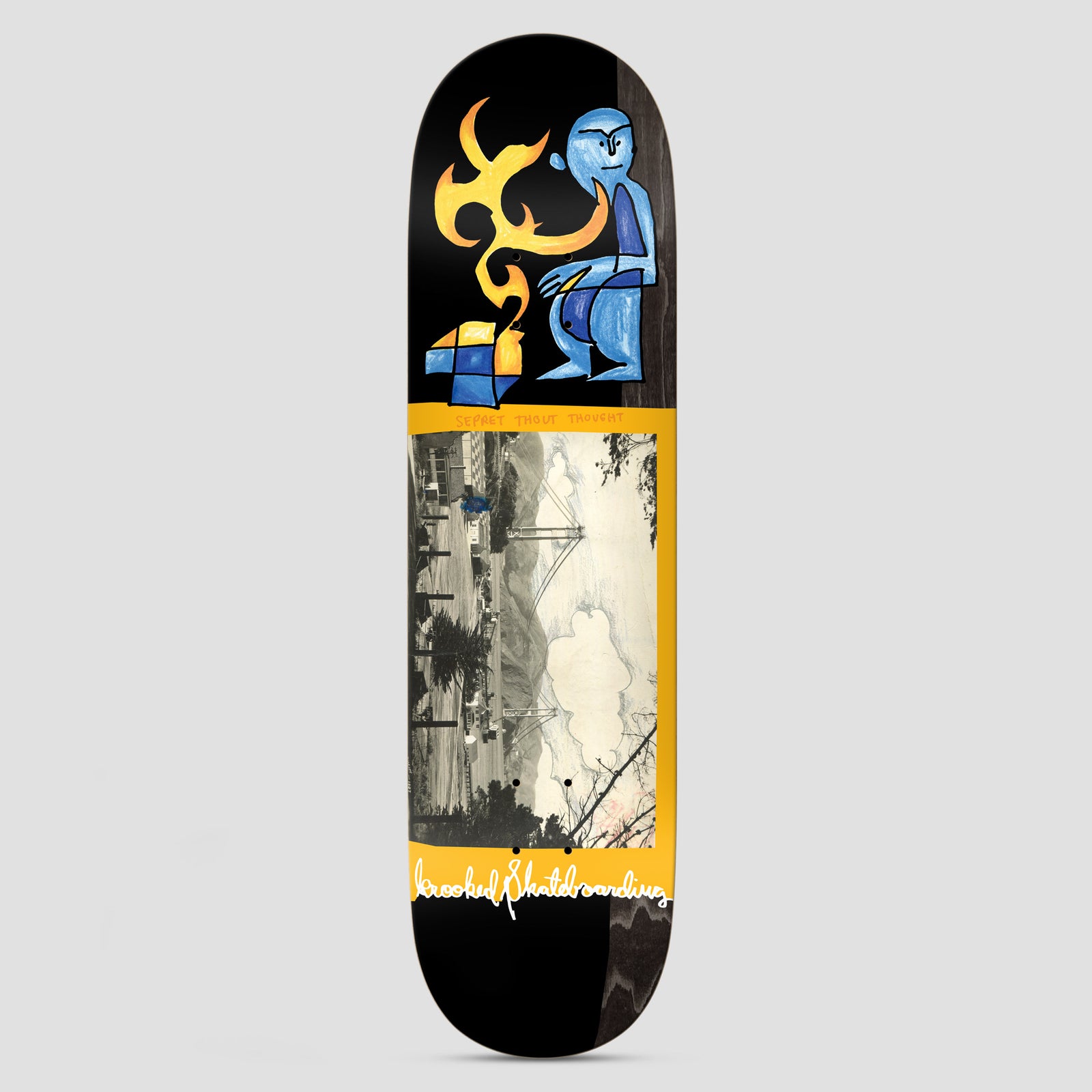 Krooked Cernicky Bridge skateboard deck: Black deck with a blue figure and a yellow flame-like shape at the nose, above a yellow-framed panel with a sepia photograph of a suspension bridge and hills. Krooked Skateboarding handwriting at the tail.