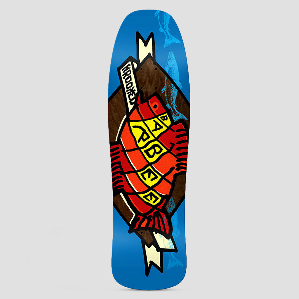 Krooked Barbee Trophy Blue skateboard deck: Shaped blue deck with a large red fish scored with yellow blocks spelling BARBEE, set on a brown diamond with cream ribbons reading Krooked, and faint blue fish in the background.