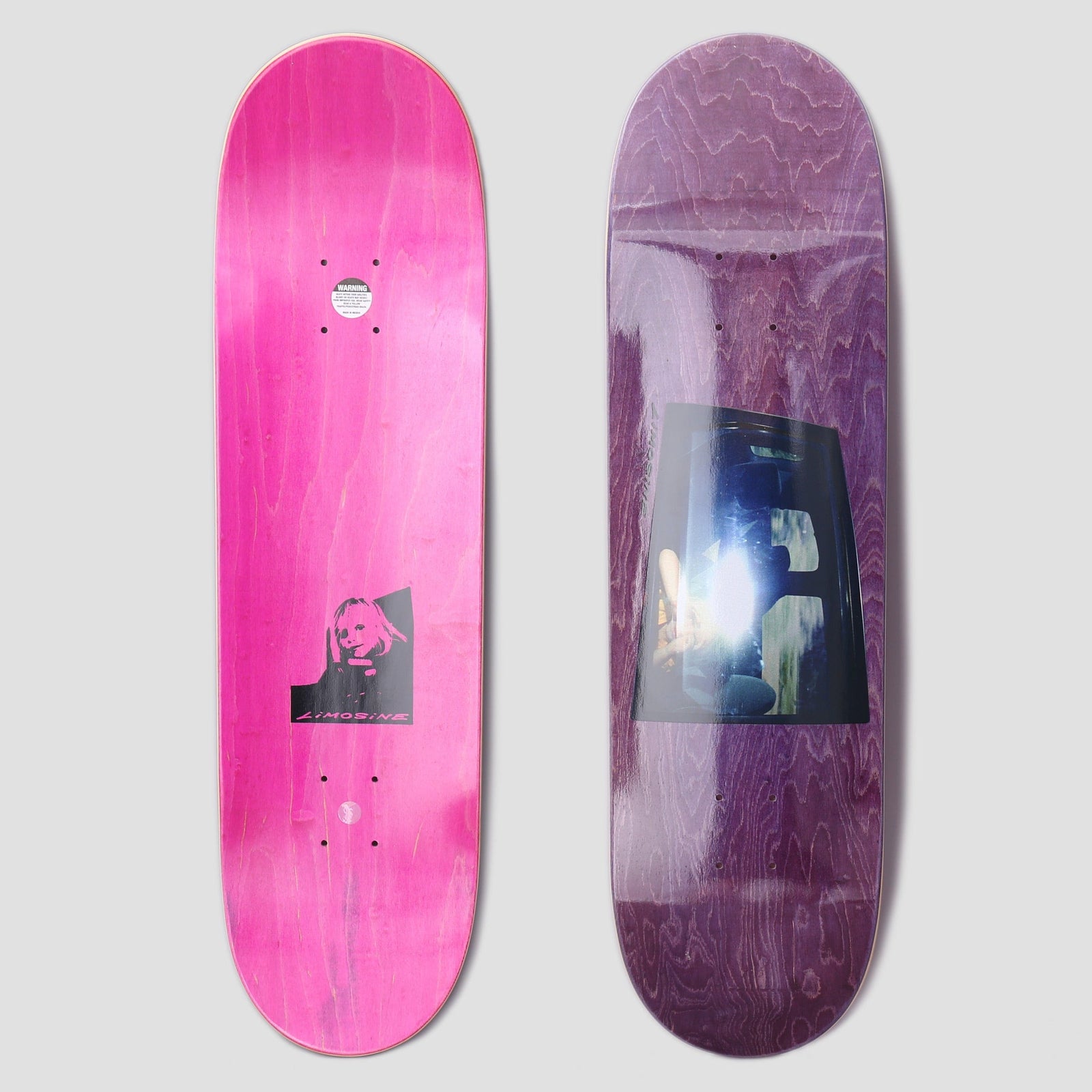 Limosine Cyrus Bennett Window Purple skateboard deck: Purple-stained deck with a photograph of a bright-lit car window interior with seats, set as a rectangular panel. The underside shows pink stain with a small black portrait of a blonde woman.