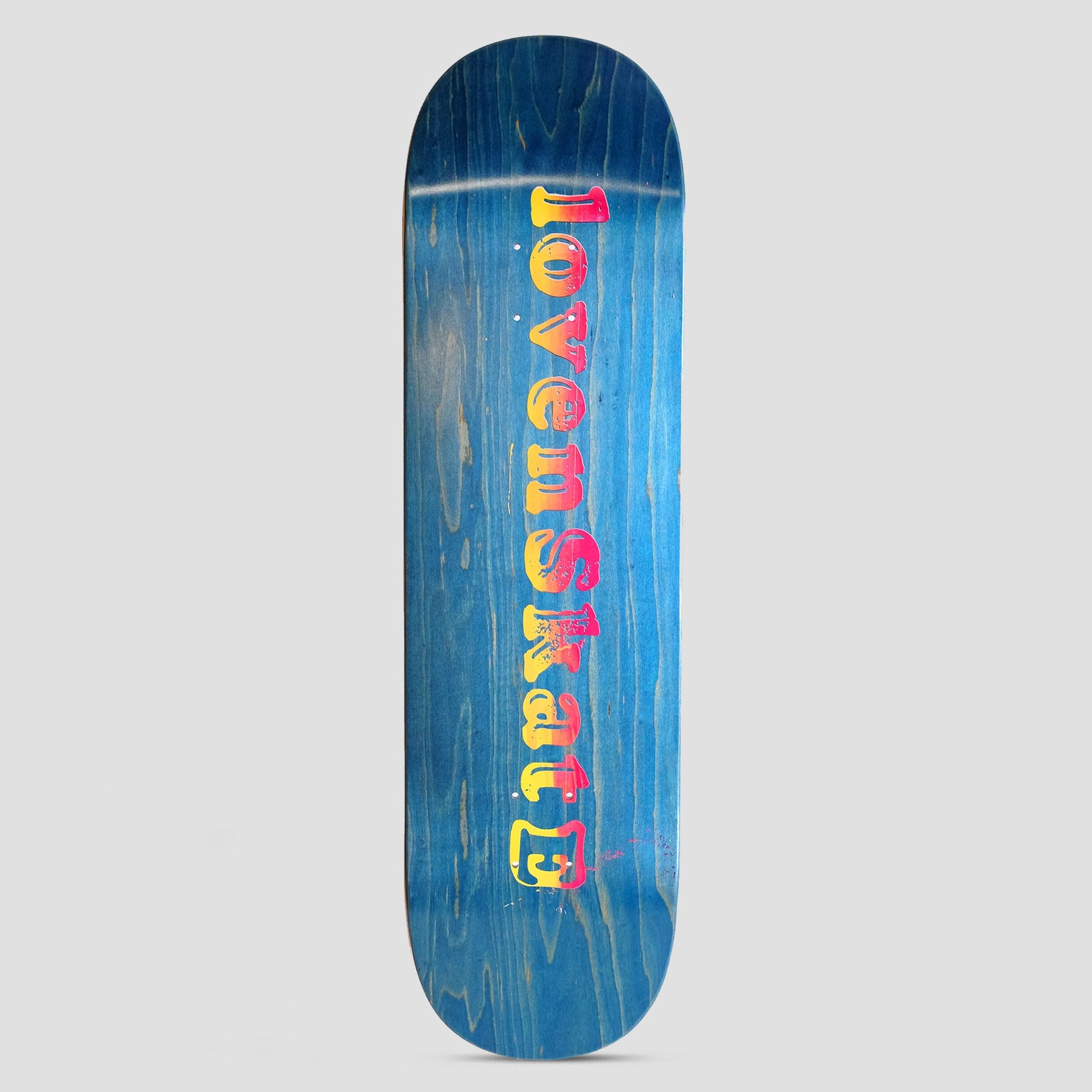 Lovenskate Blend Simple skateboard deck: Blue-stained deck with the shop name printed lengthways in a chunky, distressed serif typeface, fading from pink to yellow, ending with a small boxed symbol.
