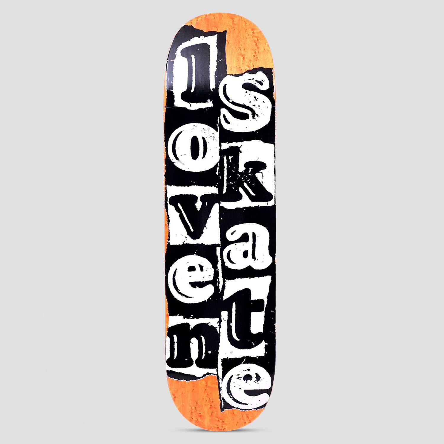 Lovenskate Tear Logo skateboard deck: Torn ransom-note style lettering in white on black paper strips spells 'love' and 'skate' in two columns, with orange wood veneer showing at the edges.