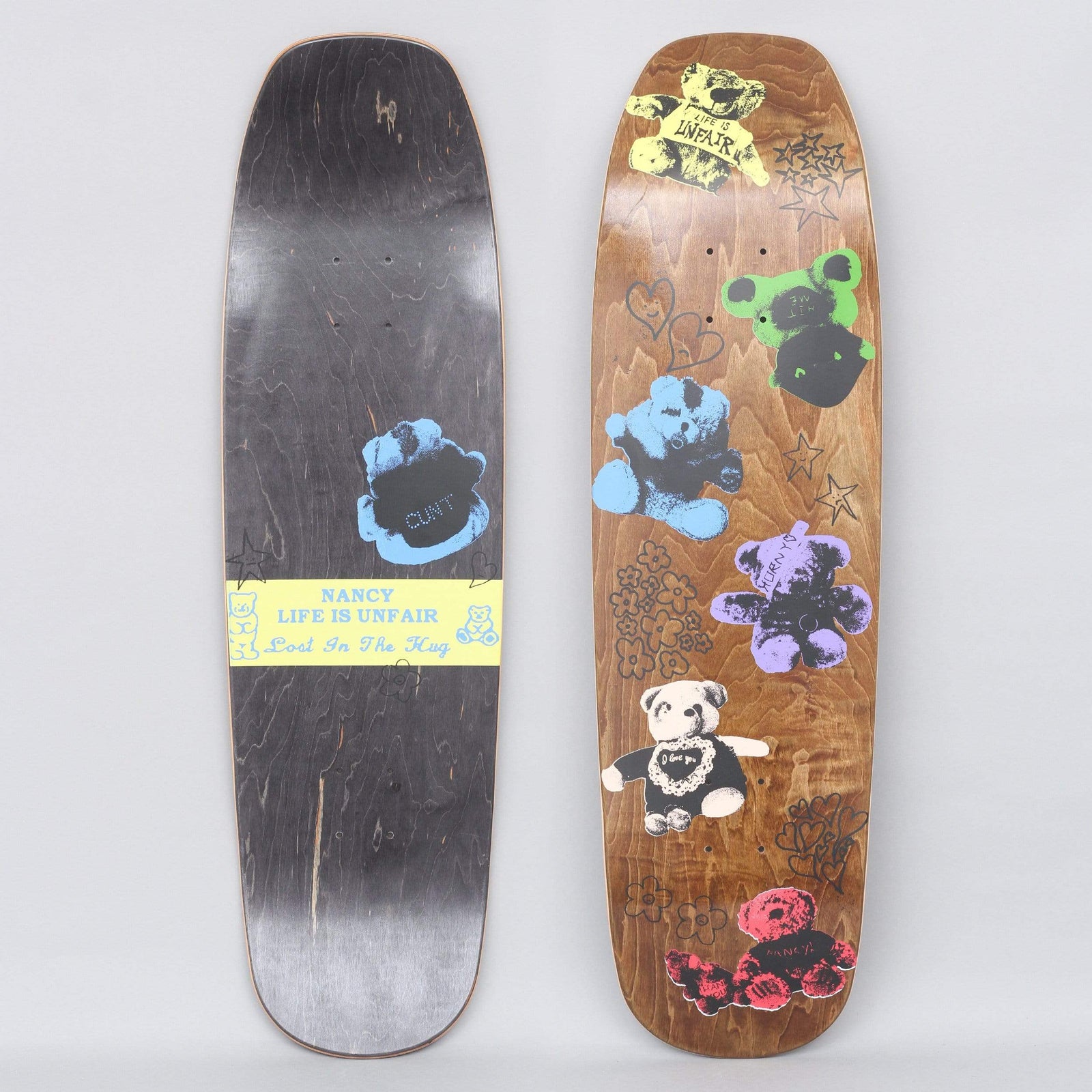 Nancy x Life Is Unfair 9 Teddies skateboard deck: Both sides shown. The top shows stained wood printed with screen-print teddy bears in yellow, green, blue, purple, white and red, surrounded by black hand-drawn hearts, stars and flowers. The underside has a blue bear and a yellow label.