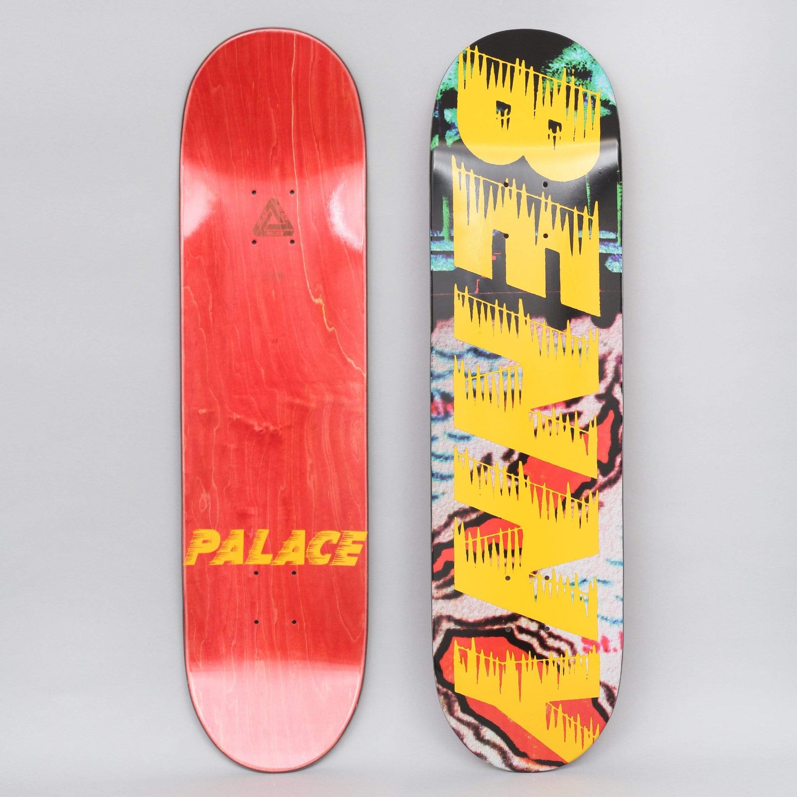 Palace Fairfax S21 skateboard deck: Large yellow dripping-edge capital letters spelling out a word running vertically over a glitchy photographic collage in teal, red, black and white. The reverse is red stain with a yellow 'PALACE' wordmark and a small triangle logo.