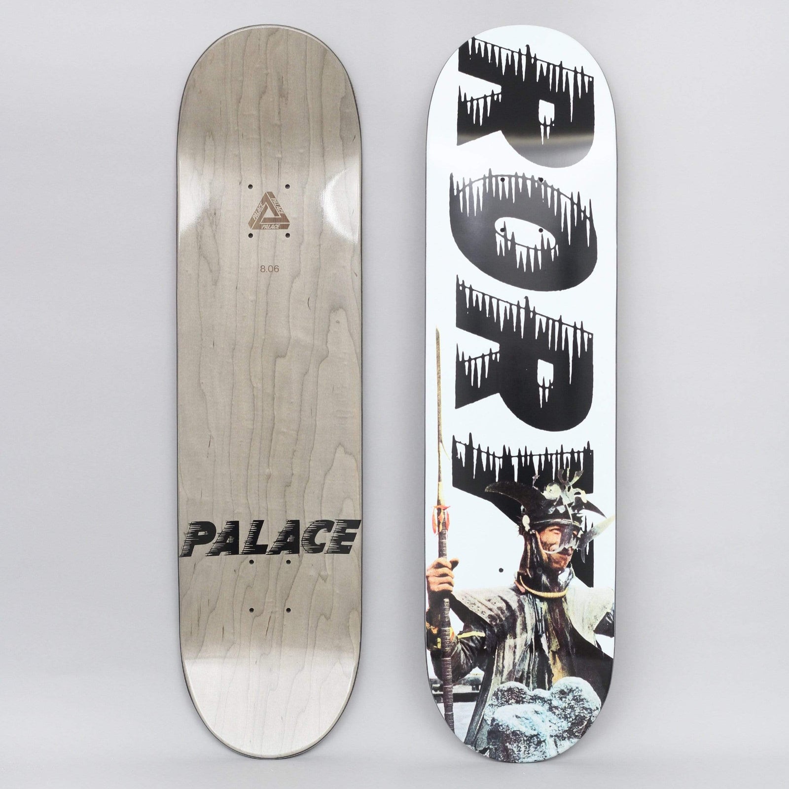 Palace Rory S21 skateboard deck: White deck with the name Rory in huge black letters stacked down the board, each edged with dripping icicles. A collaged figure in samurai-style helmet and robes holding a long spear stands at the bottom.