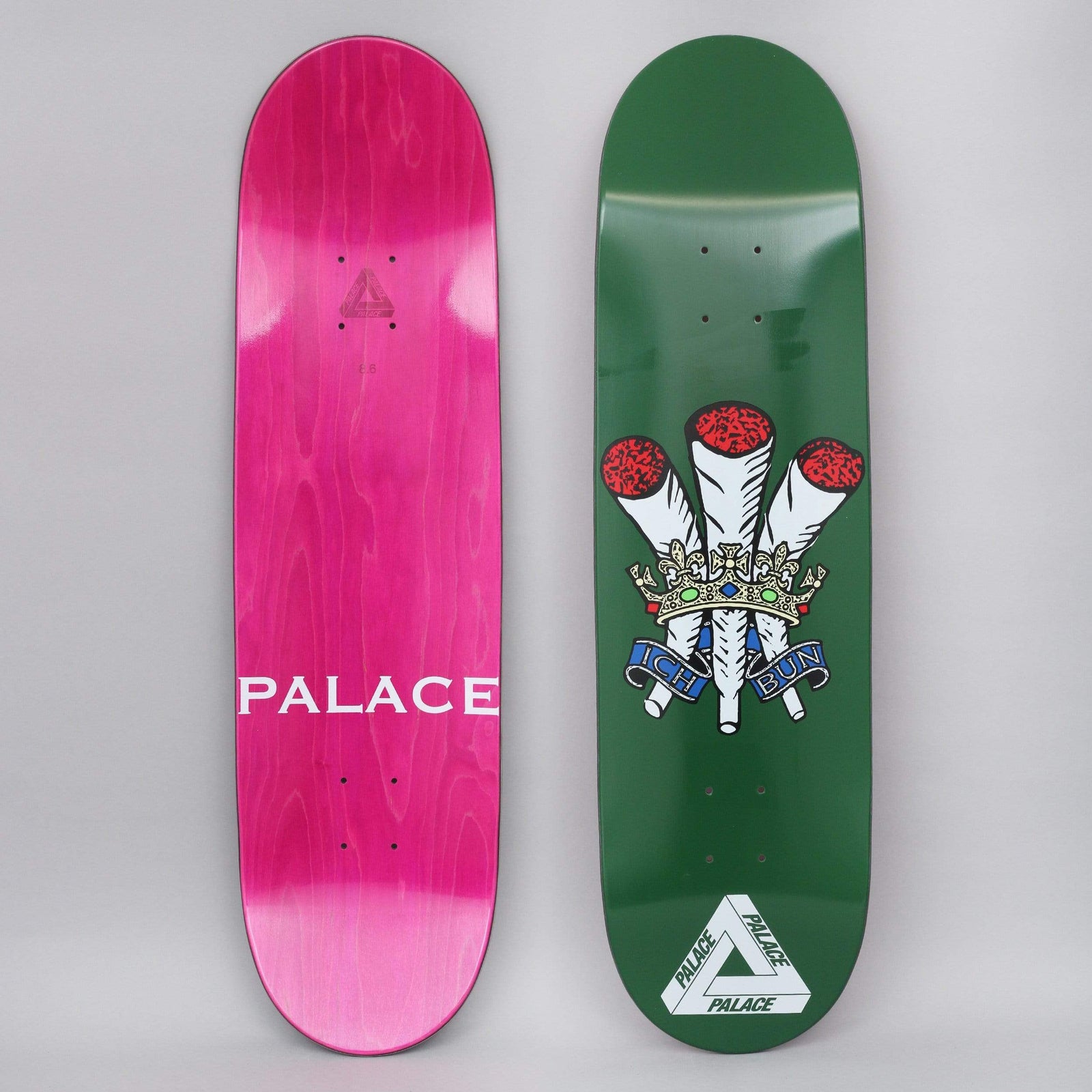 Palace Ich Bun Green skateboard deck: Prince of Wales feathers crest redrawn with three joints in place of the feathers, under a jewelled crown and a blue ribbon. Palace triangle logo at the tail, on dark green.