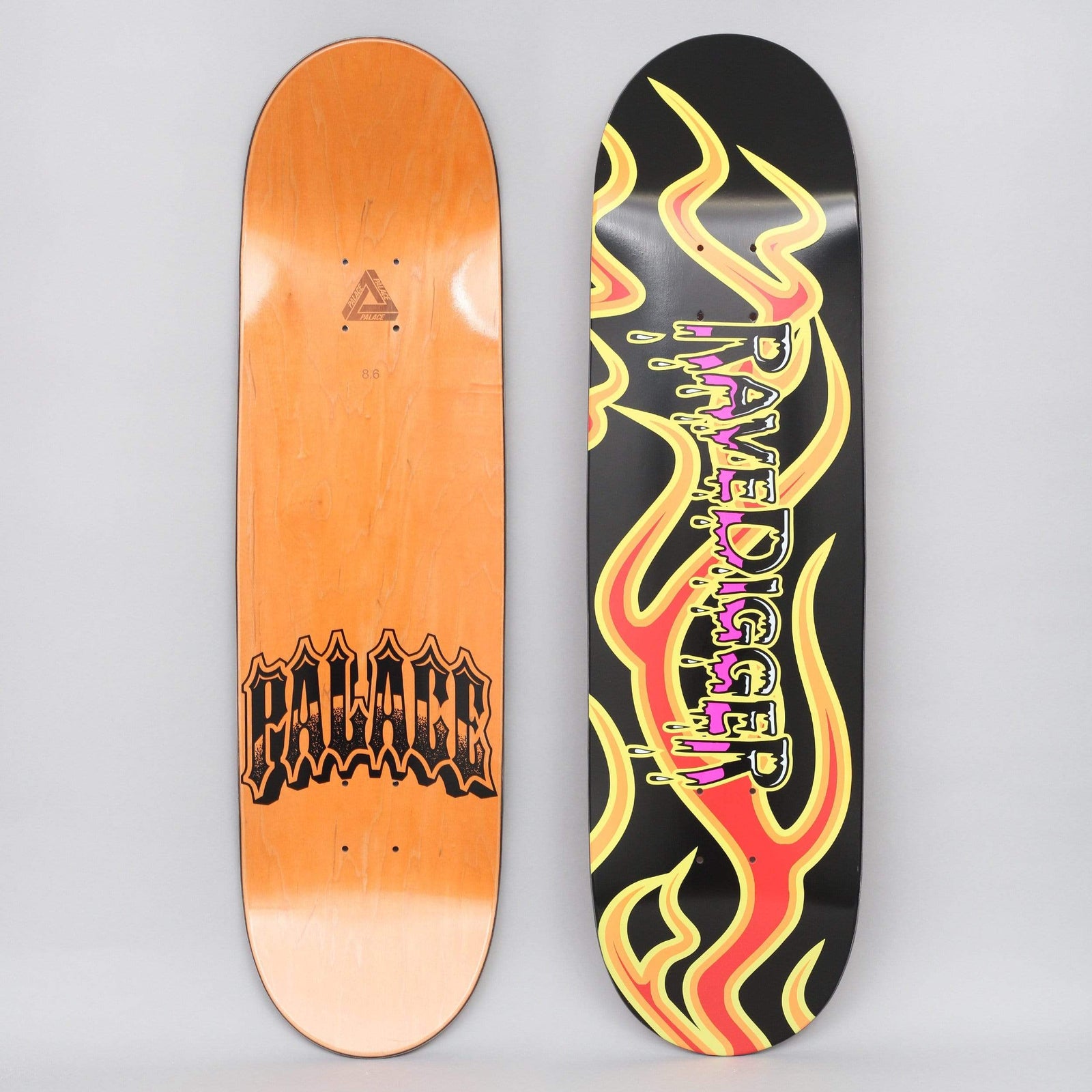 Palace Ravedigger Black skateboard deck: Black deck with large yellow, orange and red flames curling along its length behind dripping pink and yellow 'Ravedigger' lettering. The bottom carries a gothic-style Palace logo on an orange stain.
