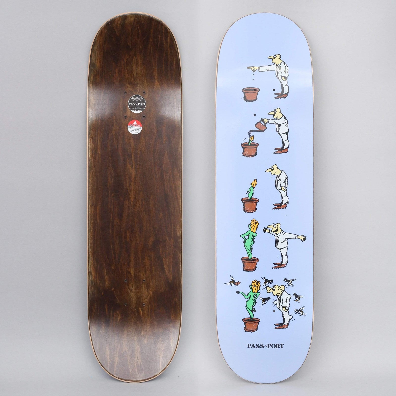 Passport W.C.W.B.F? Grow Lilac skateboard deck: Lilac deck with a five-step comic strip of a man in white tipping out a pot, watering it, growing a flower woman, then being swarmed by flies as the plant becomes a green woman. 'PASS-PORT' is printed at the tail.