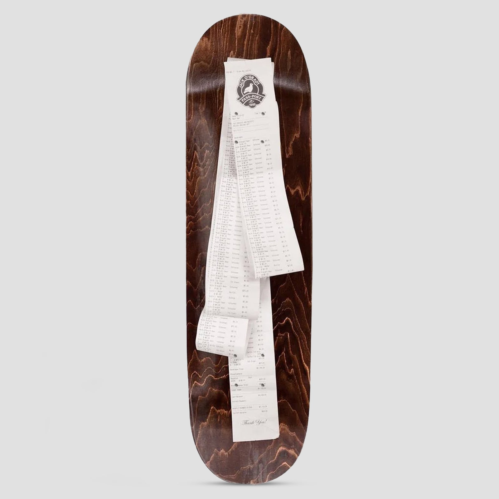 Passport Pro Series Jack Receipt skateboard deck: Brown wood-stained deck with a photograph of a very long till receipt laid down its length, with a circular logo at the top and 'Thank you!' at the bottom.