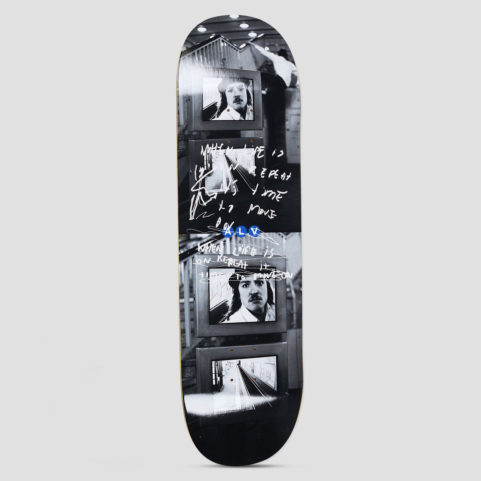 Polar Alv Markisches Museum skateboard deck: A black and white photographic design of stacked monitors showing a moustached man in a hat and a train platform, overlaid with white handwritten scrawl and a small blue ALV logo.