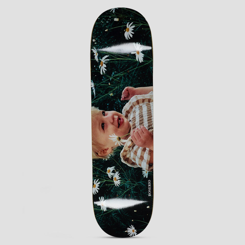 Polar Nick Boserio Cleo & Daisy skateboard deck: A full-bleed photograph of a smiling blonde toddler in a striped top among white daisies and dark grass, with 'Boserio' in small text along the edge.