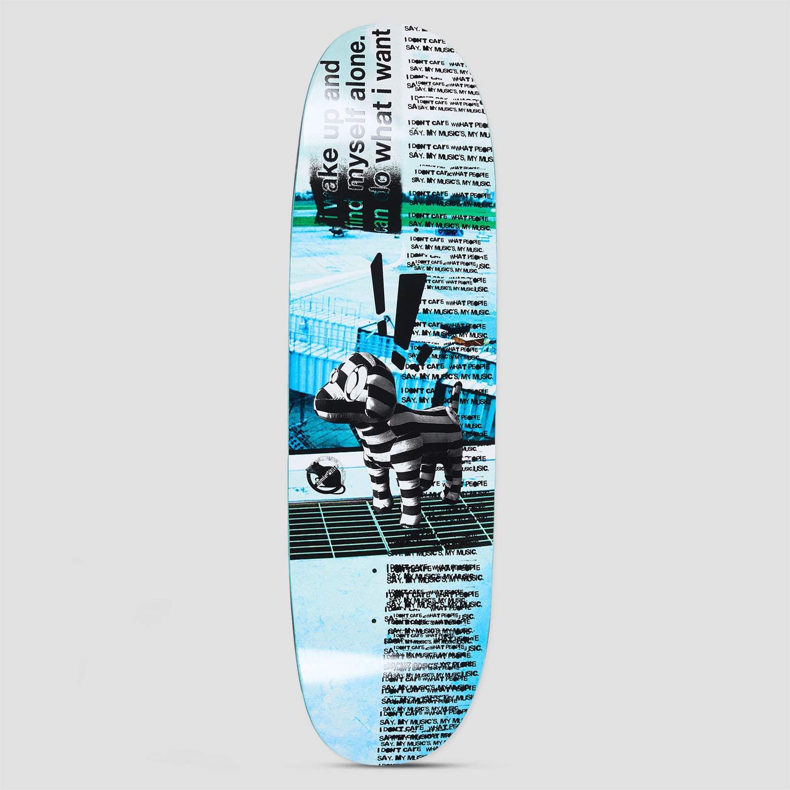 Polar Jamie Platt My Music skateboard deck: A photo of a black and white striped inflatable dog toy standing on a grid walkway against a cyan-tinted industrial scene, with a black exclamation mark above it and repeated lines of small black type.