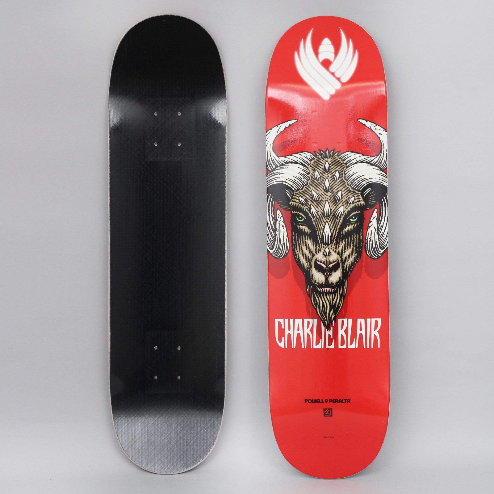 Powell Peralta Peralta 8.25 Charlie Blair Goat Shape 243 Flight Red skateboard deck: A detailed illustration of a horned goat's head with green eyes and spiked brow, facing forward on a red deck. A white winged emblem sits at the nose, the rider's name in white capitals beneath. Photo shows top and underside.