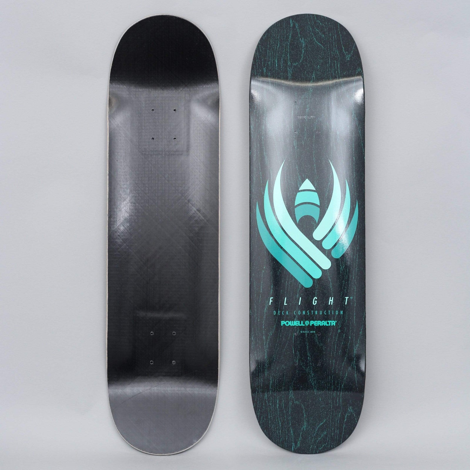 Powell Peralta Peralta 8.5 Shape 249 Flight Black Stain skateboard deck: Black-stained deck with a teal gradient emblem of winged feather shapes around a small rocket-like point, above FLIGHT Deck Construction and Powell Peralta text. Black underside shown beside it.