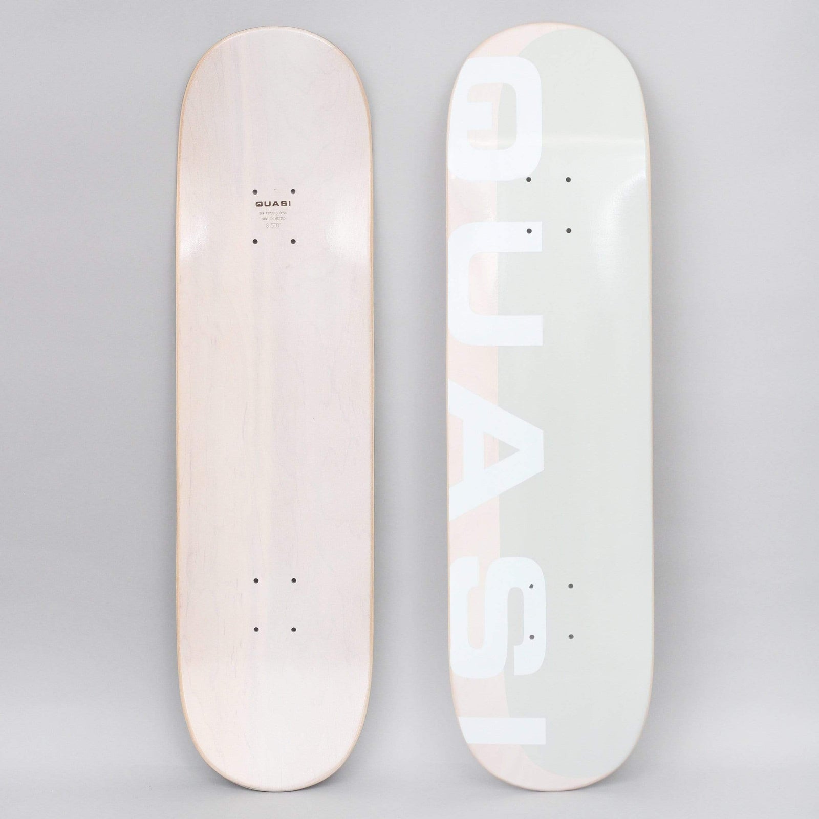 Quasi Quasi 8.5 Mono Phade Two skateboard deck: Large white block capitals spelling the brand name, running vertically and cropped at the edge, over a pale grey-green and blush pink panel. Minimal typographic design.