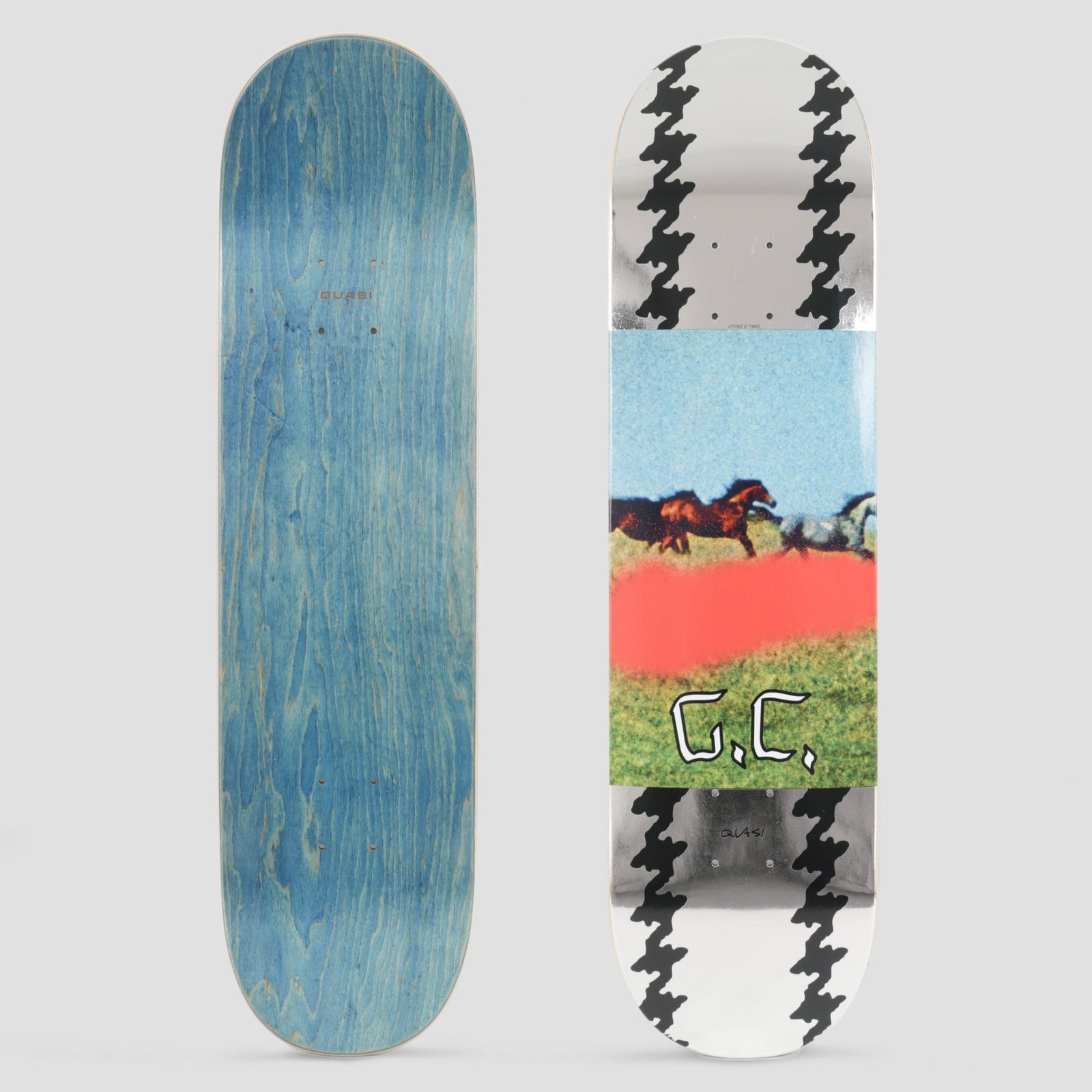 Quasi Quasi 8.125 Crockett Horses skateboard deck: Central photographic band of horses galloping across a green field under a blue sky with a blurred red patch and handwritten 'G.C.', set between silver foil panels with black houndstooth edging at nose and tail.
