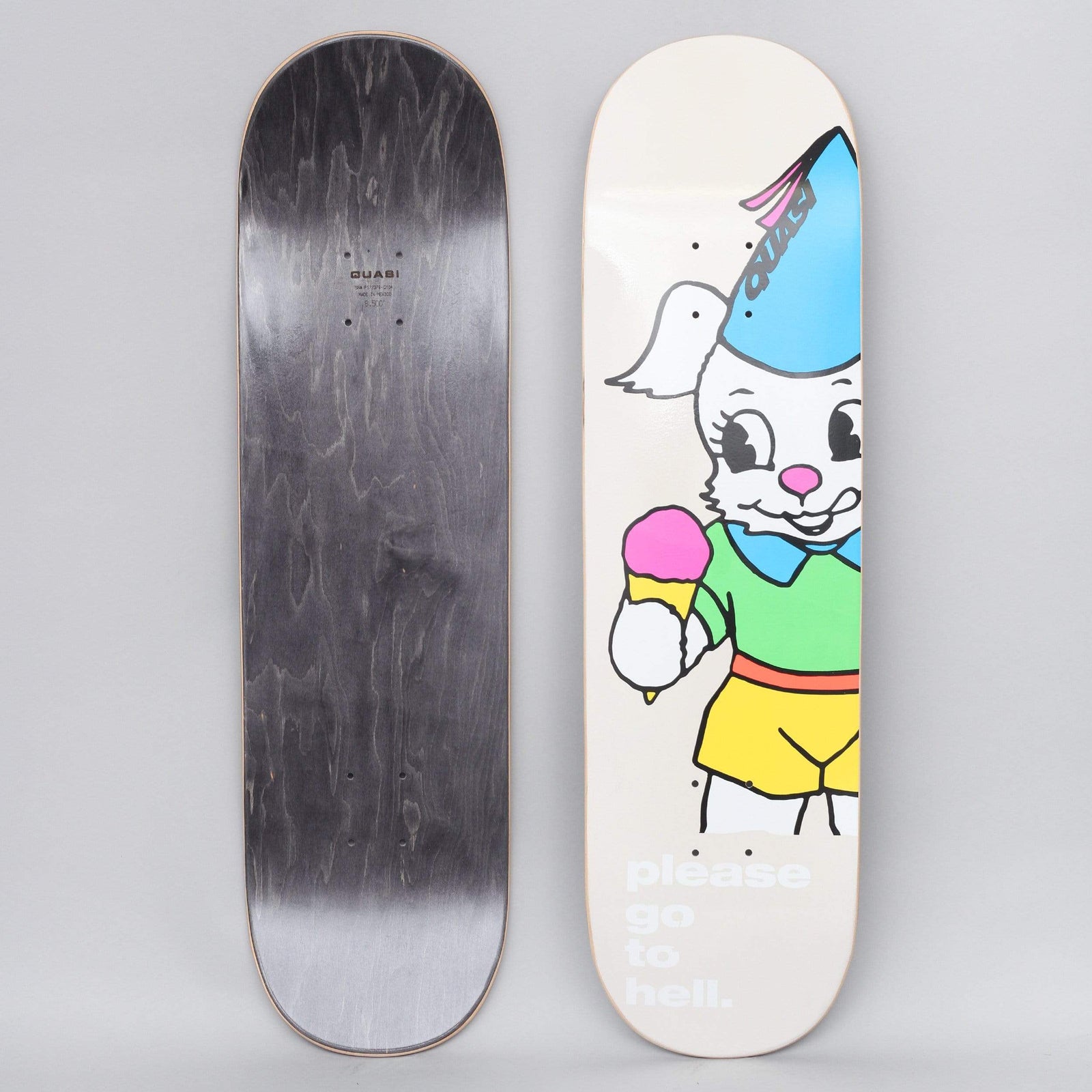 Quasi Quasi 8.5 Go To Hell Off White skateboard deck: Cartoon white rabbit in green shirt and yellow shorts, wearing a blue party hat and holding a double-scoop ice cream cone, on an off-white deck with pale white text at the tail. Black underside also shown.