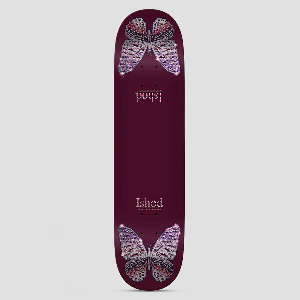 Real Ishod Mariposa Chrome Redux Twin Tail Maroon skateboard deck: Two sparkly chrome-effect butterflies with lilac and red wings sit at the nose and tail of a maroon deck, with the rider name in decorative type near each end, the nose one upside down.