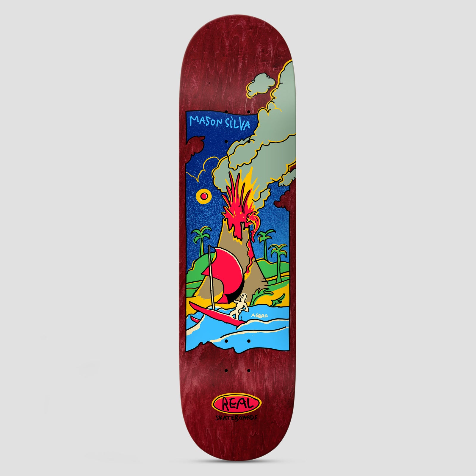 Real Mason Volcano DBX Multi skateboard deck: Framed colourful cartoon scene of an erupting volcano with palm trees and a figure on a red sailboat on a blue sea, on a dark red wood-stained deck. Rider name at top of frame and Real oval logo at the bottom.