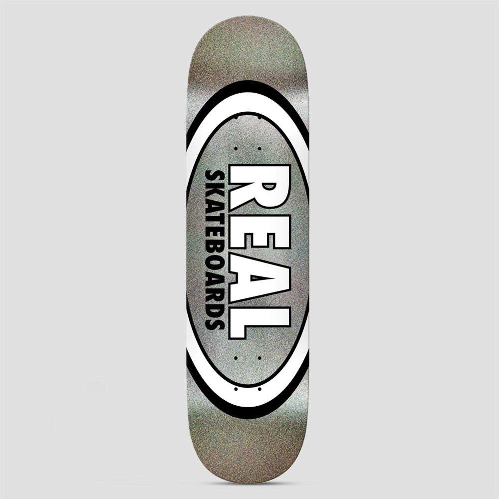 Real Team Classic Oval Easy Rider Black Holo skateboard deck: Real's classic oval logo with a white and black double ring around a grey holographic glitter centre. Large white 'REAL' with black outline sits above vertical 'SKATEBOARDS' inside the oval.