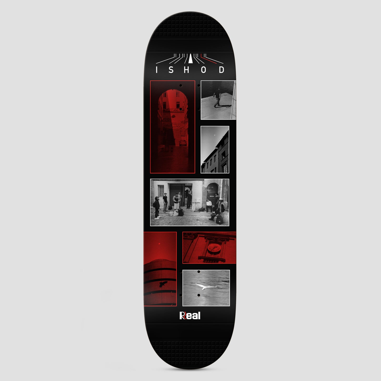 Real Ishod Photos Twin Tail Slick Black skateboard deck: Black deck with a panel layout of black and white and red-tinted photographs of old European streets, arches, a group of people, a clock and a seagull, with a road graphic and the name at the top.