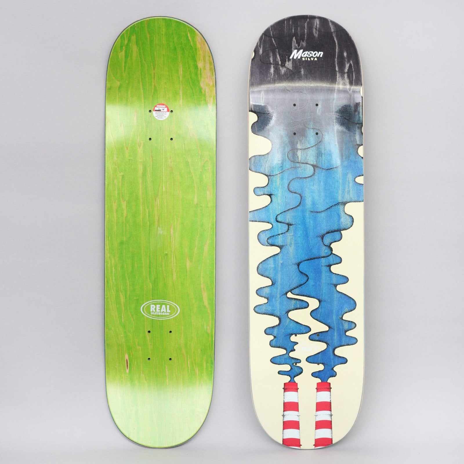 Real Mason Silva Clean Air Full skateboard deck: Two red and white striped factory chimneys at the bottom pour wavy blue smoke up a cream deck, darkening to grey and black at the top. The rider name is at the nose. The green underside is also shown.