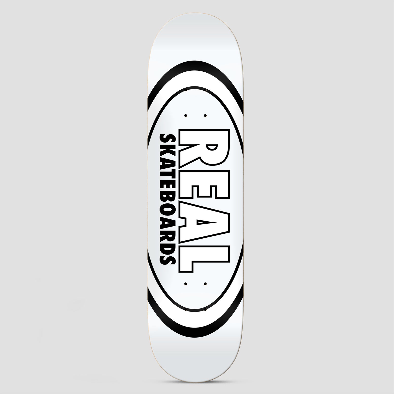 Real Team Classic Oval White skateboard deck: Real Skateboards classic oval logo with bold outlined REAL lettering and SKATEBOARDS running vertically inside a black-ringed oval, on a plain white deck.