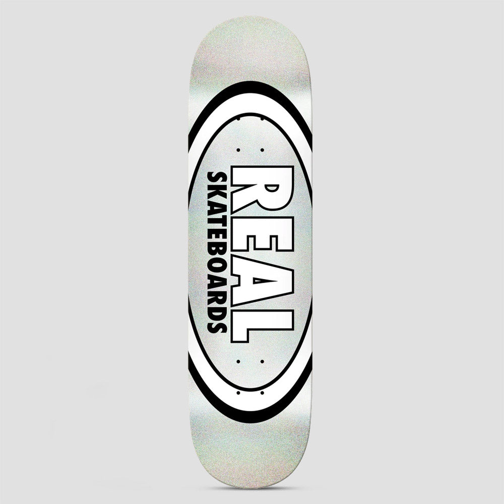 Real Team Classic Oval Easy Rider Silver Holo skateboard deck: Real's classic oval logo with a white and black double ring around a pale silver holographic centre. Large white 'REAL' with black outline sits above vertical 'SKATEBOARDS'.