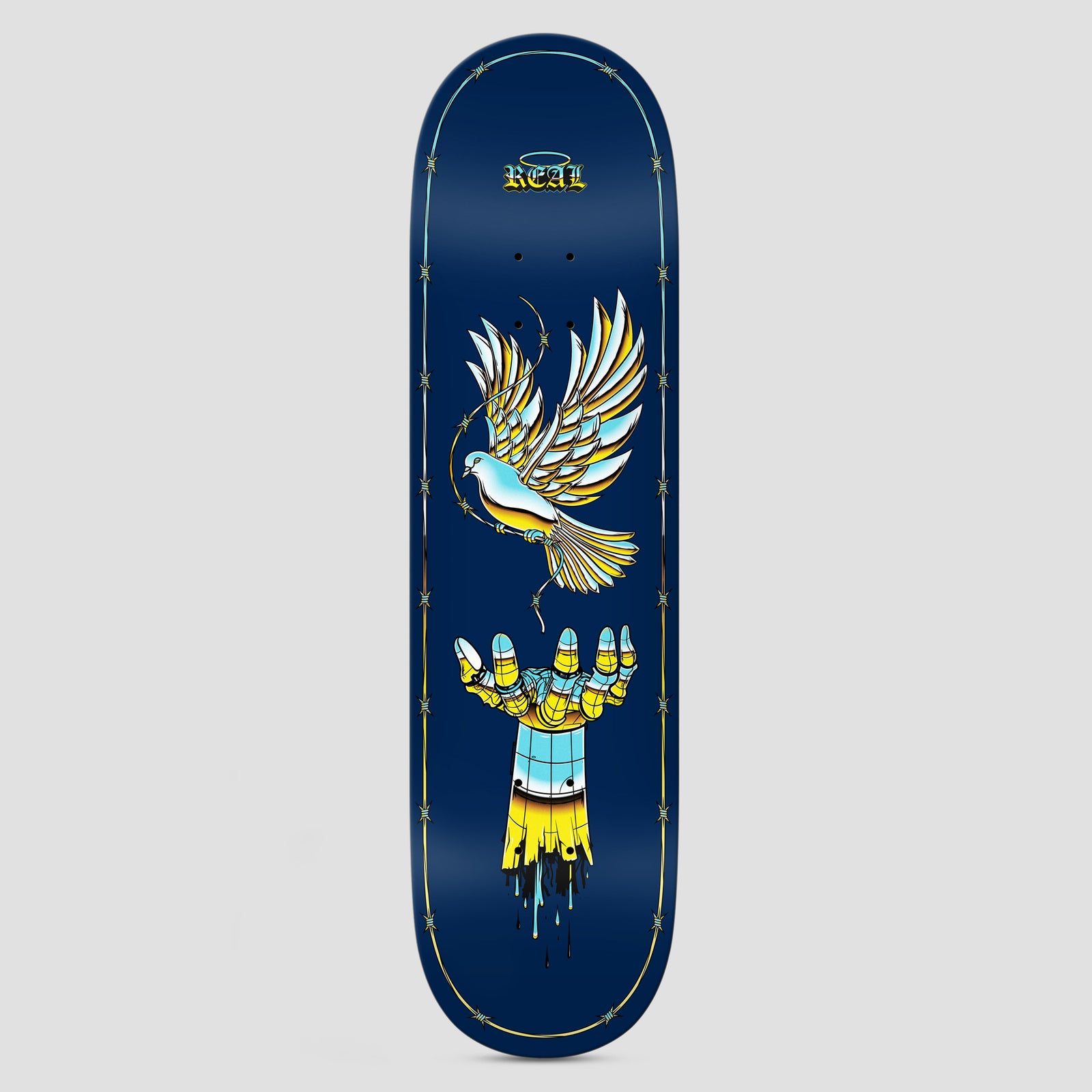 Real Team Synthetic Peace Dark Blue skateboard deck: Tattoo-style dove with a barbed wire strand flies above an open hand, both in glossy yellow and sky blue chrome-like shading, on a navy deck with a barbed wire border and a small Real logo with halo.
