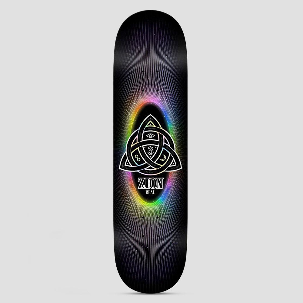 Real Zion Power Of Threes Easy Rider Black skateboard deck: Interlocking triquetra knot containing an eye, a 3 and a crescent moon, glowing in a rainbow gradient oval with fine radiating lines, on black. Zion and Real printed beneath.