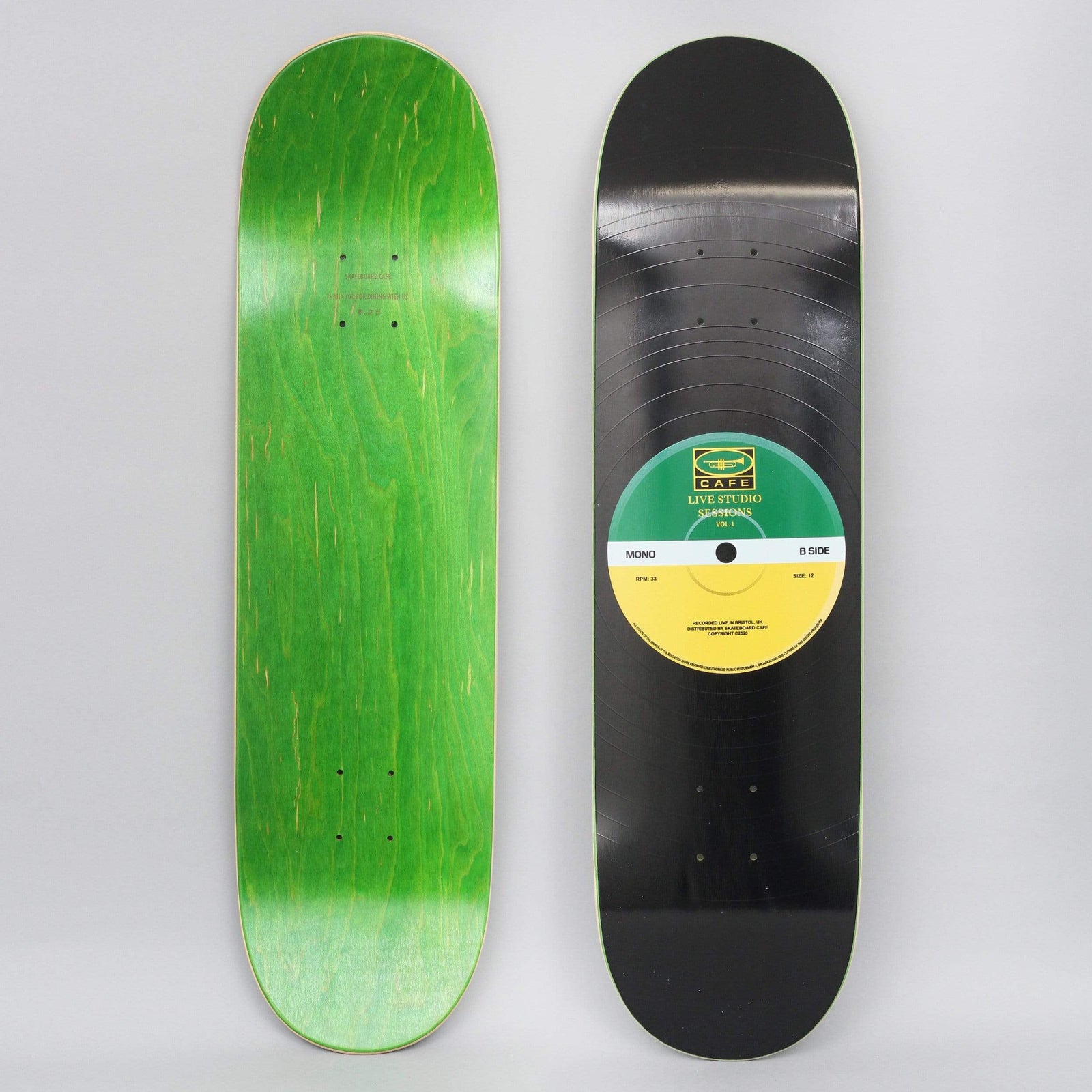 Skateboard Cafe 45 Green / Yellow skateboard deck: A black vinyl record with fine grooves covers the deck, with a green and yellow centre label reading 'Live Studio Sessions Vol. 1' and 'Mono B Side'. The underside is shown in green stain.