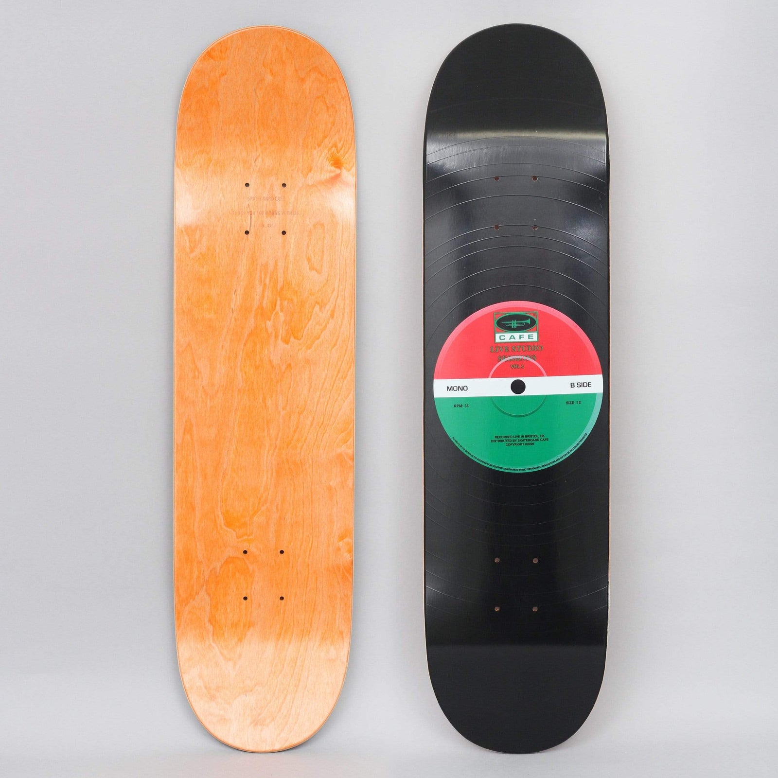 Skateboard Cafe 45 Red / Green skateboard deck: Black vinyl record design covering the deck, with grooves and a red and green centre label reading Cafe, Mono and B Side.