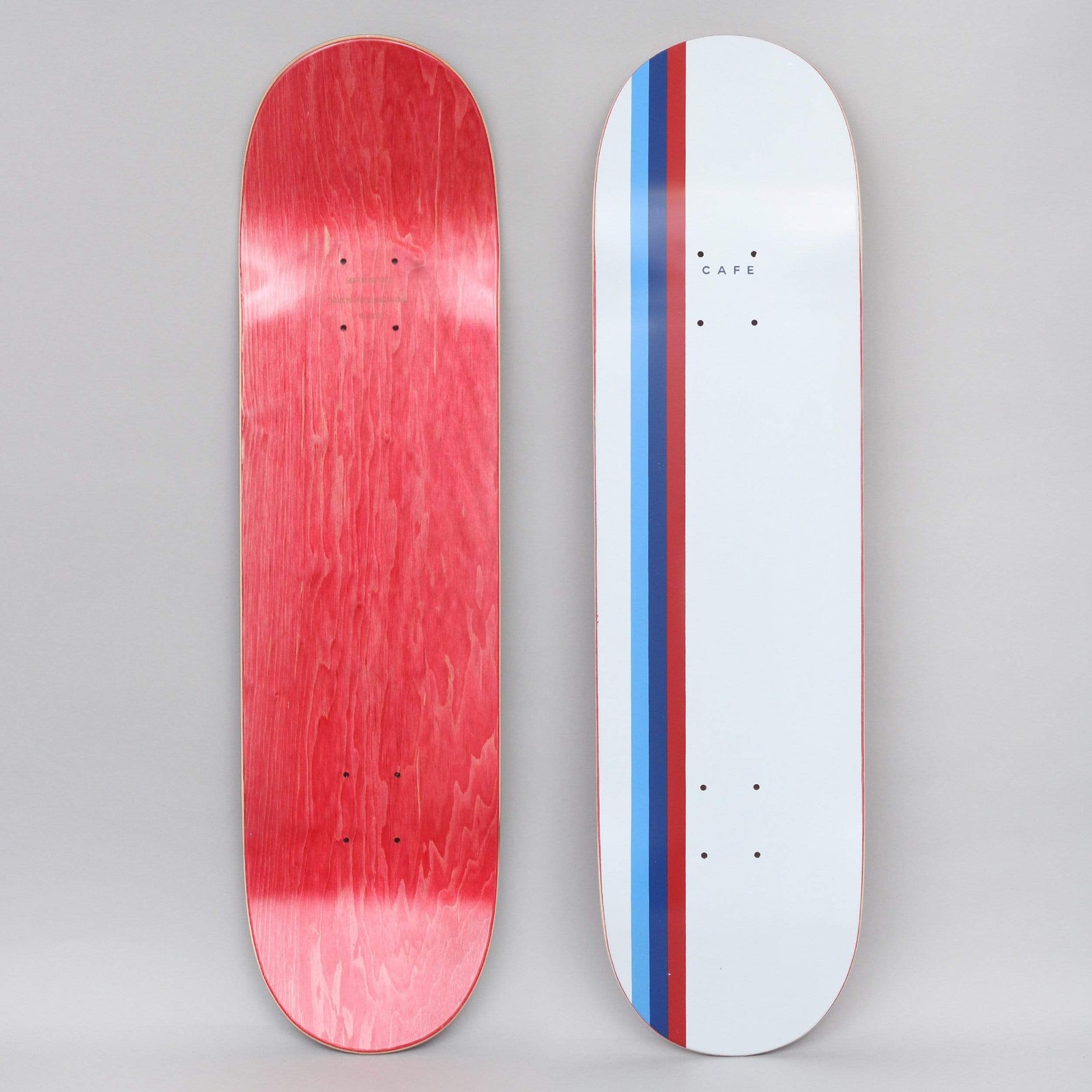 Skateboard Cafe Stripe White / Blue / Navy / Red skateboard deck: White deck with three vertical stripes in light blue, navy and red running along the left, and a small Cafe word in the upper section. Red stained underside shown alongside.