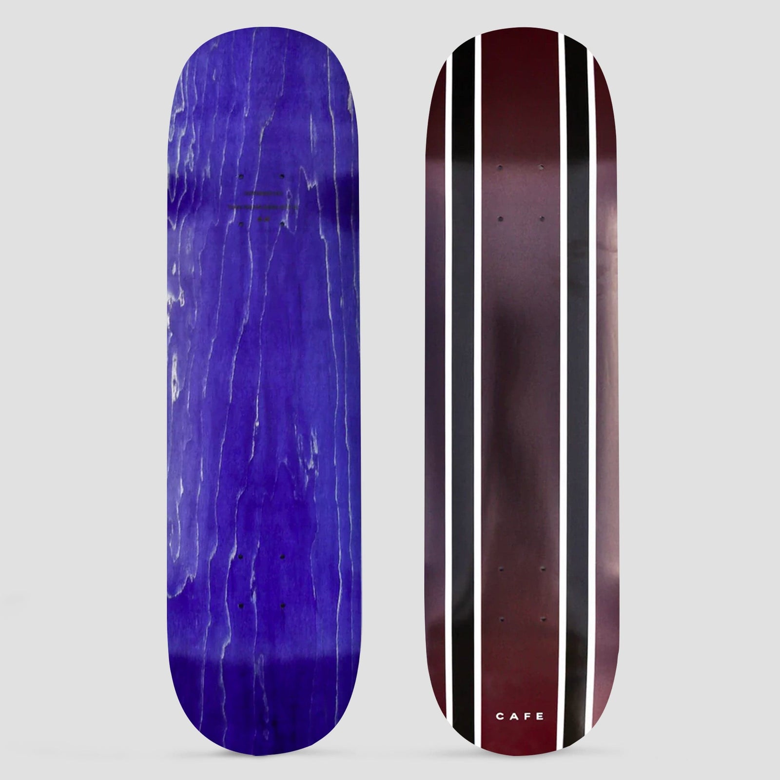 Skateboard Cafe Double Stripe Burgundy / Black Fade skateboard deck: Two pairs of black and white vertical stripes running down a burgundy deck that fades to black at the edges. Small 'Cafe' text near the tail. Underside is purple stained wood.
