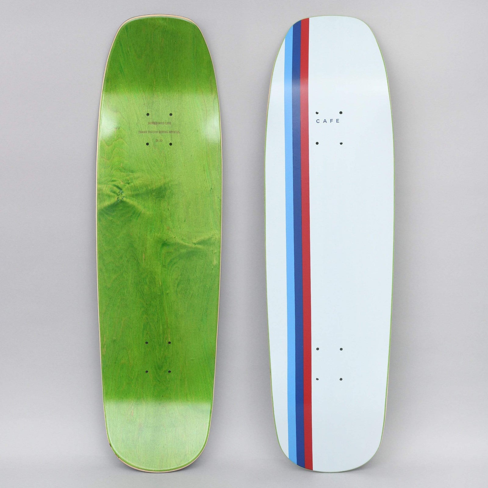 Skateboard Cafe Stripe Cruiser White / Blue / Navy / Red skateboard deck: Pale blue-white cruiser-shaped deck with three narrow stripes in light blue, navy and red running down one side, and a small 'Cafe' wordmark near the top.