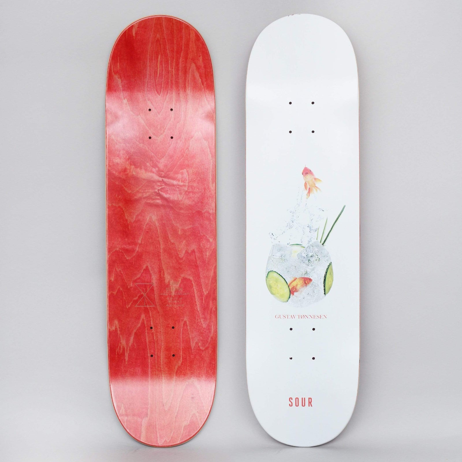 Sour Gustav G&T White skateboard deck: Both sides shown. The top shows a photographic gin and tonic in a round glass with ice, cucumber slices and two goldfish, one leaping out, on a white deck. The rider's name and a small red Sour logo sit below. The underside is red wood.
