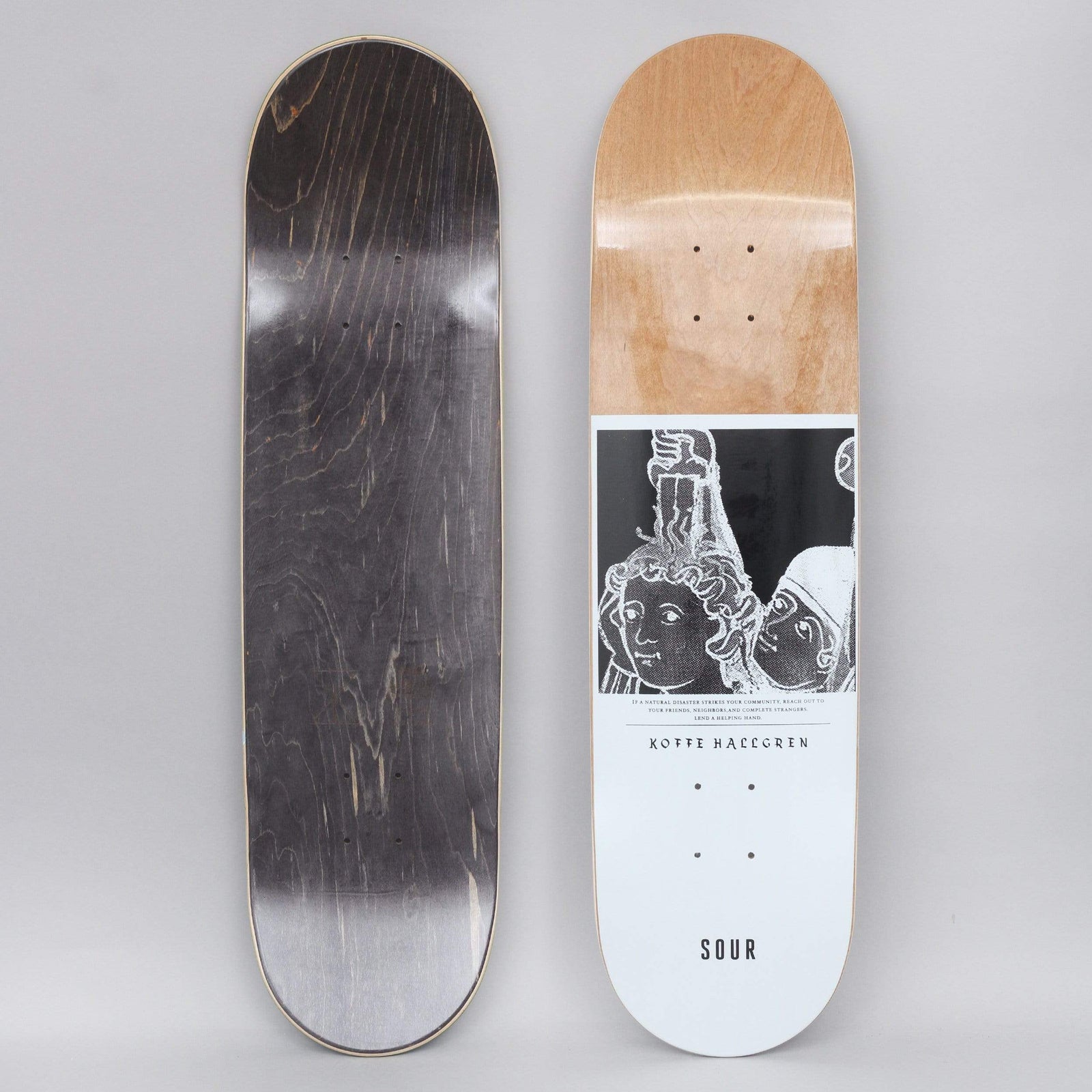 Sour Koffe Helping Hand White skateboard deck: White deck with natural wood at the nose and a black-and-white inverted image of medieval-style figures with raised arms, above a small printed paragraph and rider name. Sour logo at the tail; a black stained underside is also shown.