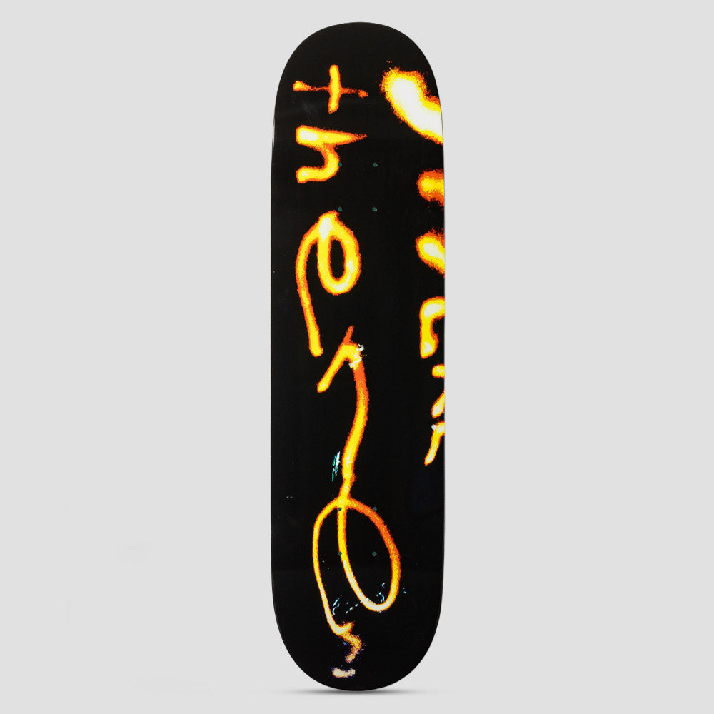 There Team Burning Black skateboard deck: Glowing orange and yellow light-trail handwriting spelling out 'there' and an extra word on a black deck, like a long exposure photo of a burning wire.