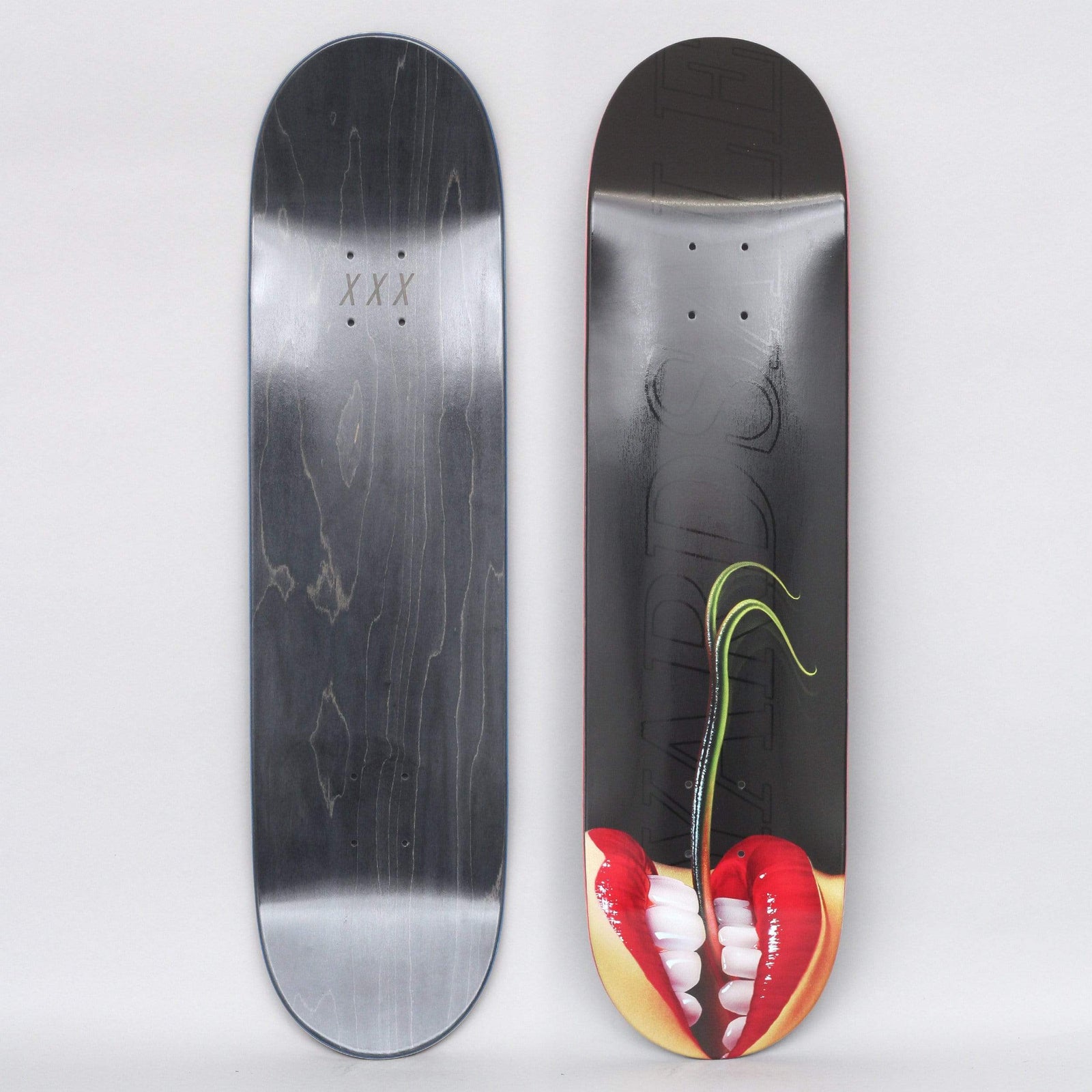Yardsale Sedusa Black skateboard deck: Close-up photograph of red-lipped mouth with white teeth at the tail, a green plant shoot growing up from between the teeth, on a black deck with faint outlined lettering. Underside is black with XXX marks.