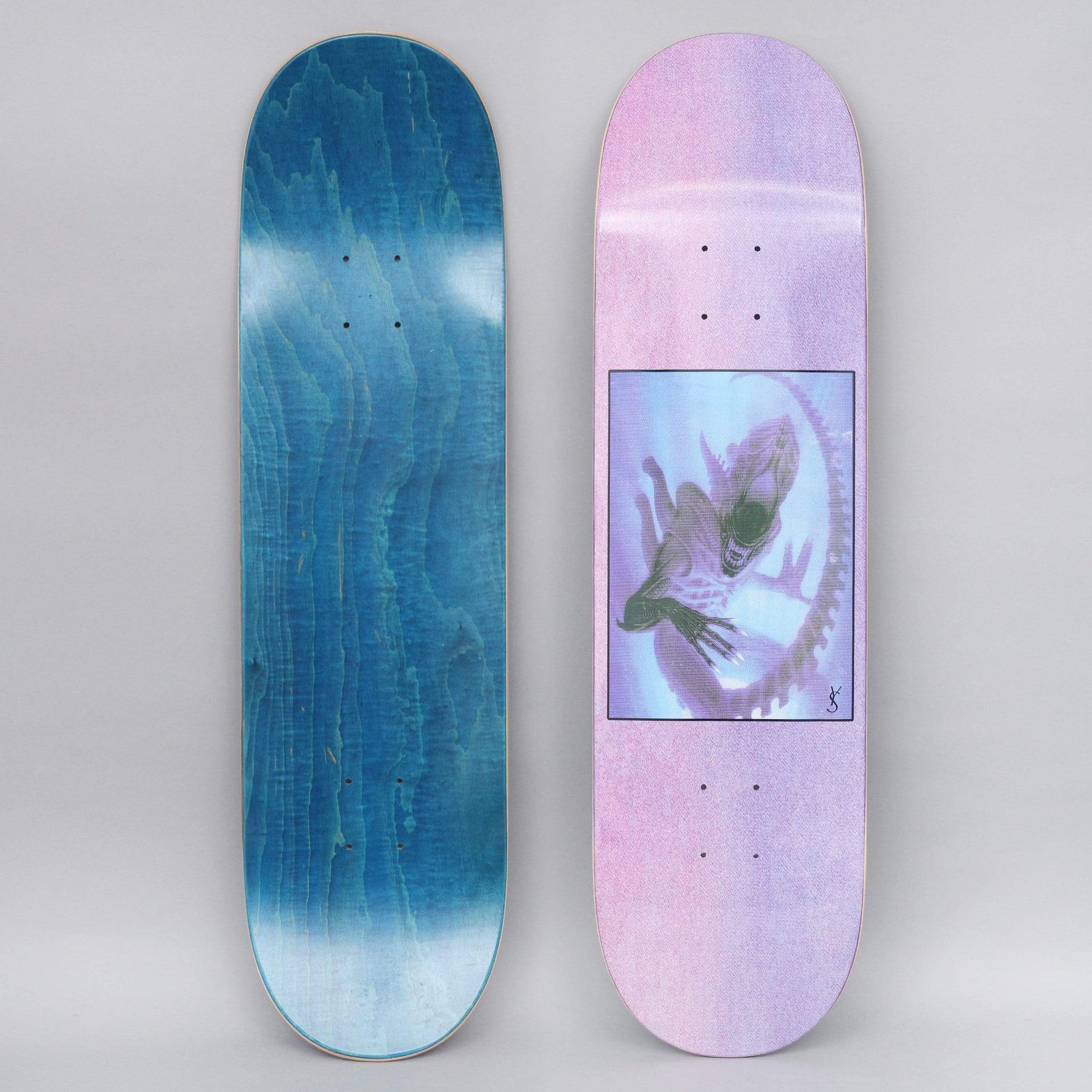 Yardsale Evolution B Purple skateboard deck: A framed, hazy illustration of a xenomorph-style alien creature curled in a ring on a pastel pink-to-lilac gradient with a grainy texture, signed in the corner.