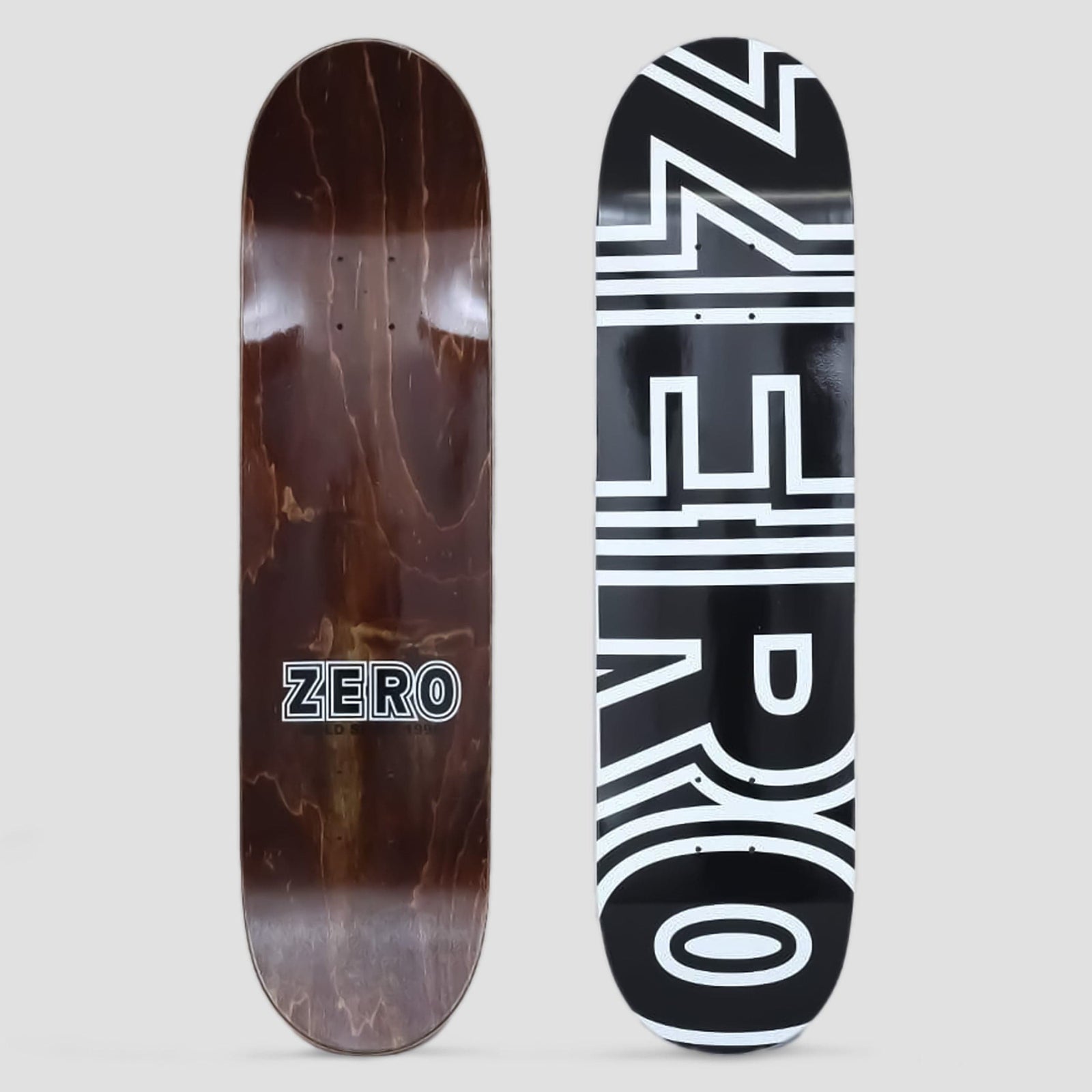 Zero Zero 8.0 Bold Black / White skateboard deck: Huge white outlined Zero lettering running up the length of a black deck, with the letters cropped at the top. Brown wood underside with a smaller Zero logo shown alongside.