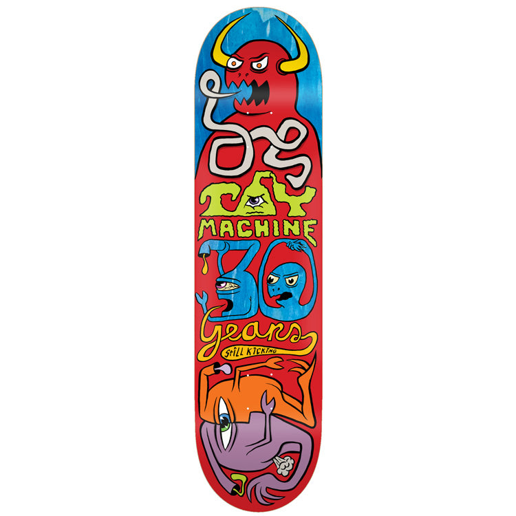 Toy Machine 30 Year Logo 8.38 skateboard deck: A red deck with blue top, showing a horned red monster blowing a wiggly line that forms the Toy Machine lettering, blue 30 with two faces, cursive Years text, and an upside-down orange and purple creature at the bottom.