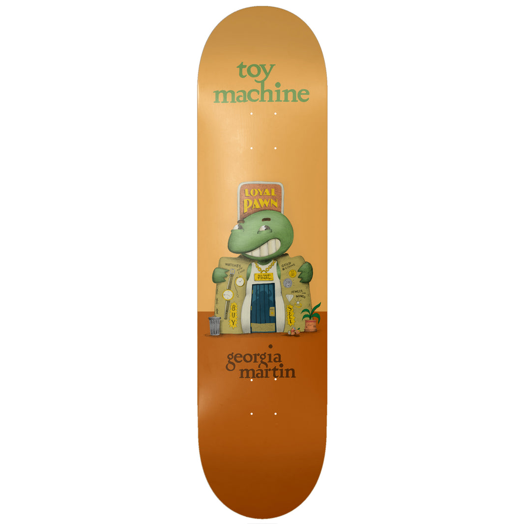 Toy Machine Georgia Martin Roadside 8.25 skateboard deck: A green turtle-like monster with a toothy grin standing as a pawn shop, with a Loyal Pawn sign on its head, gold chain, watches and Buy and Sell signs on its coat, on an orange two-tone background.