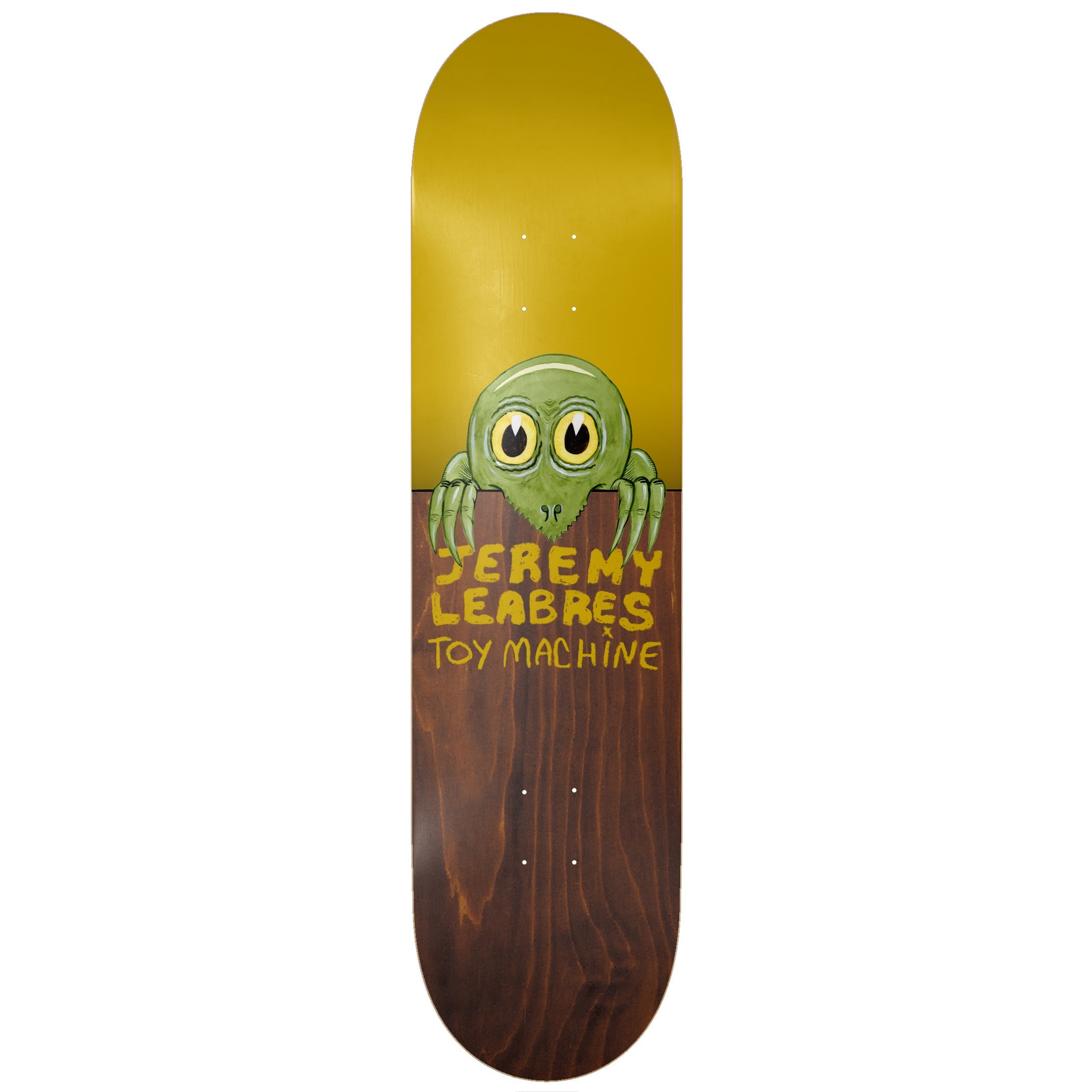 Toy Machine Jeremy Leabres Fence 8.50 skateboard deck: Cartoon green creature with big yellow eyes and long claws peering over a fence, formed by the split between a mustard-yellow upper deck and brown wood-stained lower half. Yellow hand-lettered names below.
