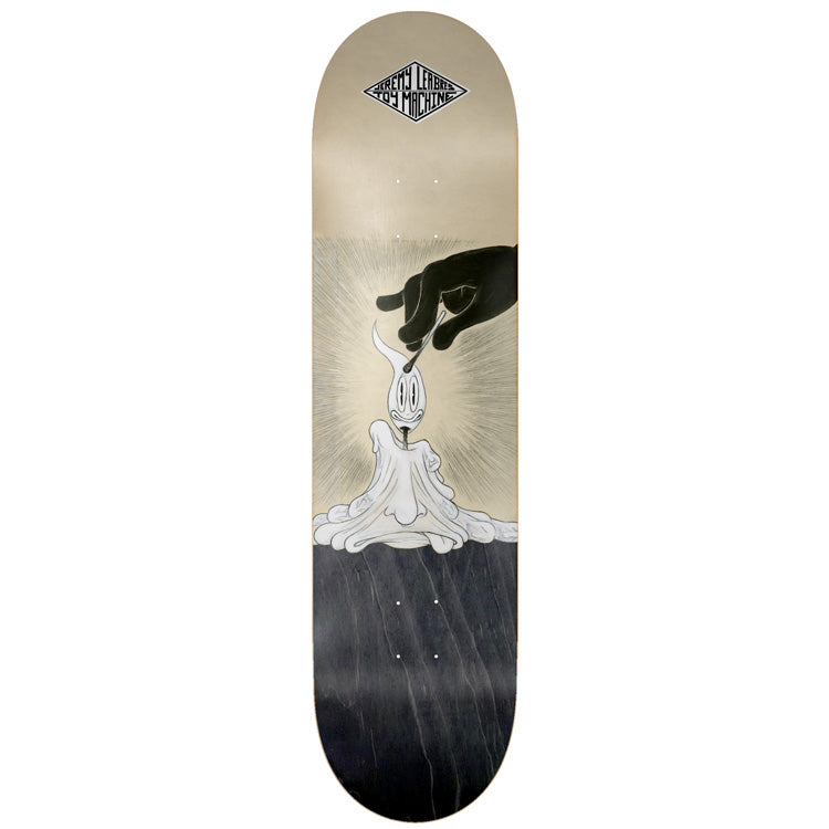 Toy Machine Jeremy Leabres / Ladouceur 8.38 skateboard deck: Black hand lighting a melted candle whose flame is a cartoon face, with light rays behind, on a split cream and dark grey wood deck. Diamond logo at the top.