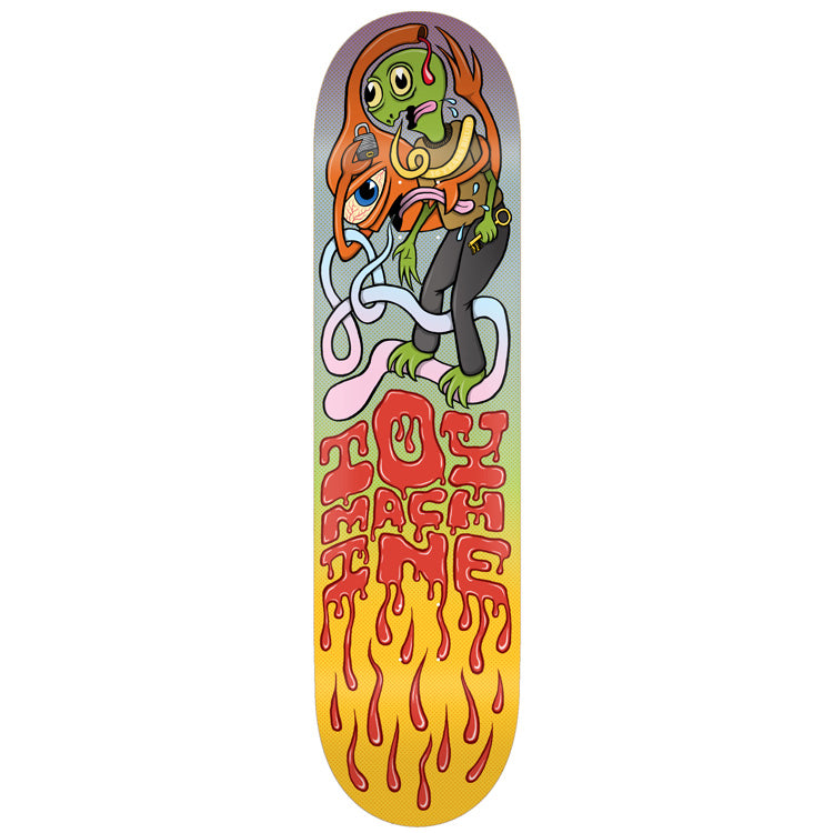Toy Machine Lock And Key 8.25 skateboard deck: A cartoon green creature with a many-eyed head inside an orange hood, holding a key, tangled in pale pink and white tentacles with a floating eyeball and padlock. Red dripping 'Toy Machine' lettering runs down the lower half over a yellow-orange gradient.