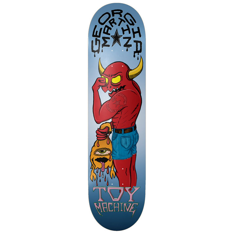 Toy Machine Georgia Martin Monster 8.25 skateboard deck: A muscular red horned devil in blue shorts holds a dripping orange one-eyed monster by the hair, wiping its own glowing yellow eye. Dripping gothic rider name arches over a star at the top on a blue gradient.