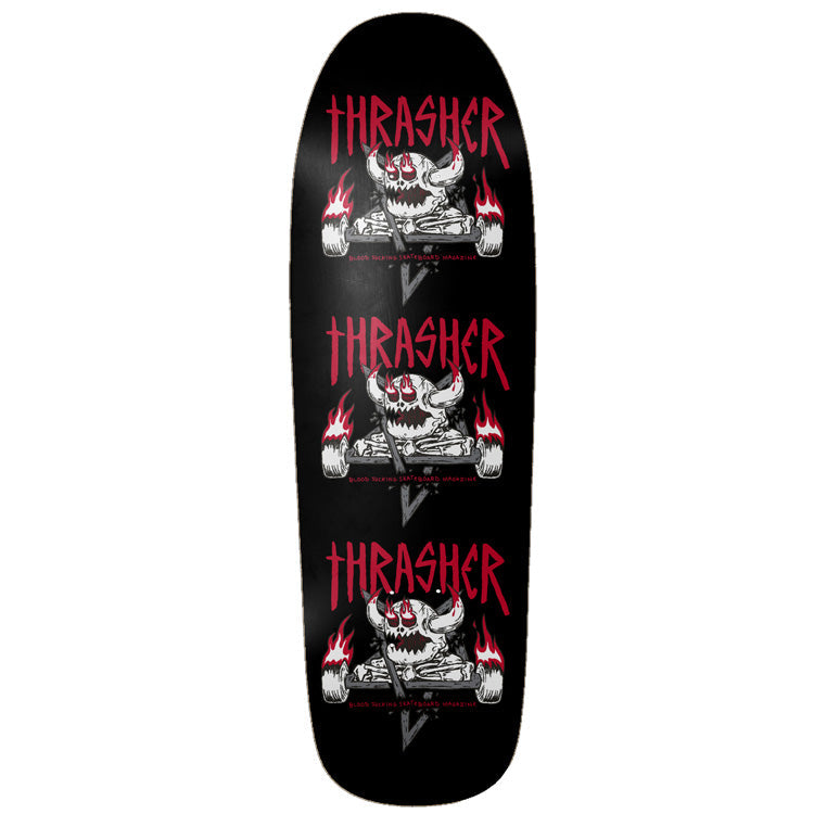 Toy Machine X Thrasher Monster - Gram 9.50 skateboard deck: The Thrasher magazine logo in red above a horned Toy Machine monster skull with flaming wheels and crossed bones, repeated three times down a black shaped deck. Small red text runs under each skull.