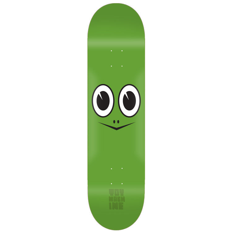 Toy Machine Turtle Face 7.75 skateboard deck: A plain green deck with a simple cartoon turtle face: two large round eyes and a small V-shaped mouth with nostrils. Faint Toy Machine lettering near the tail.